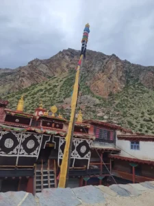 तिलगाउँमा ढुङ्गाले बनेका घरहरू पहाडको पृष्ठभूमिमा